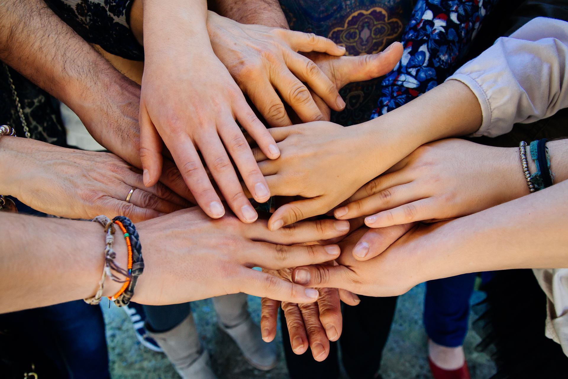 Stock image - hands over hands depicting team work and diversity. 