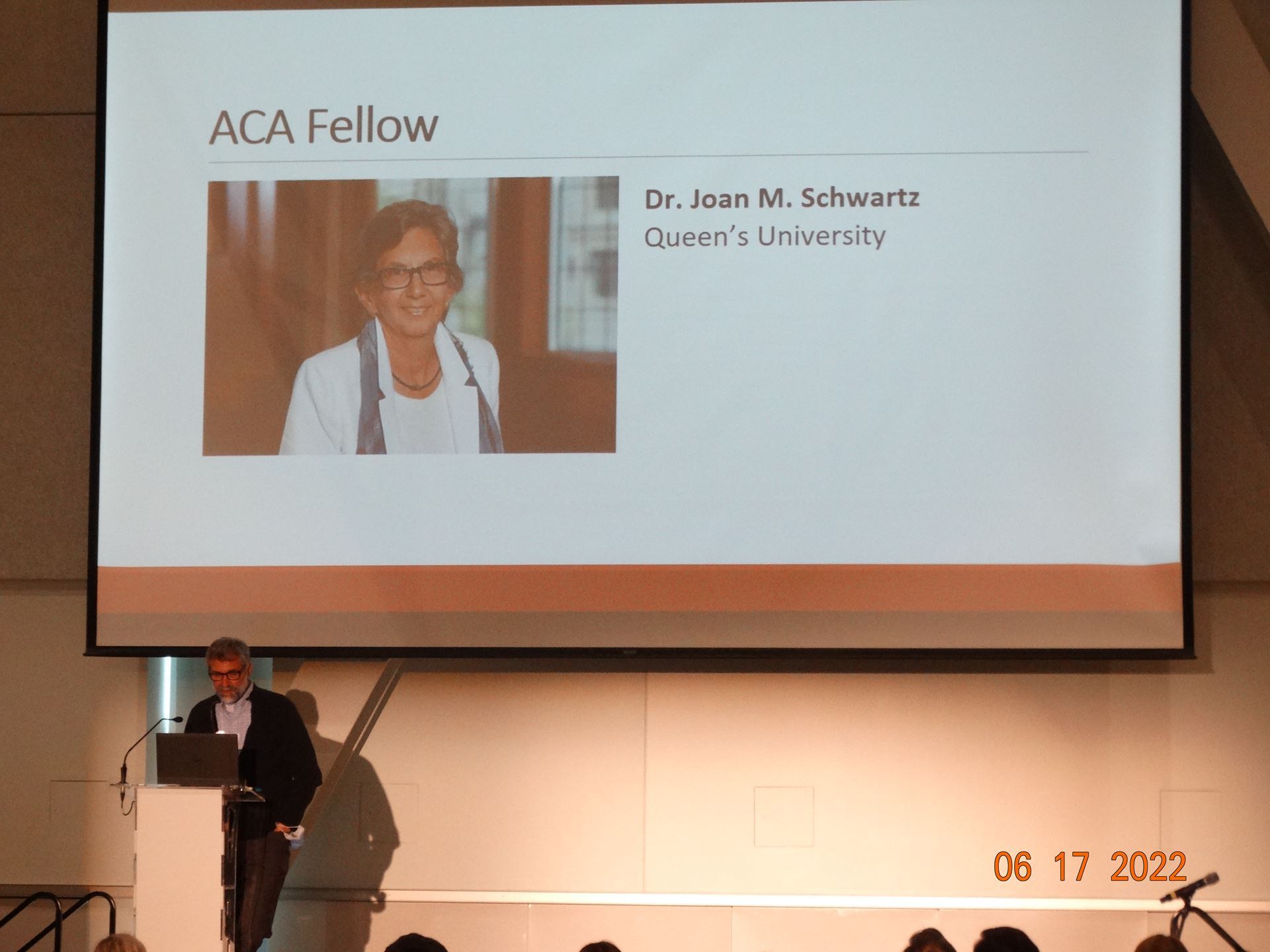 Greg Bak introducing Dr. Joan Schwartz, appointed ACA Fellow. 